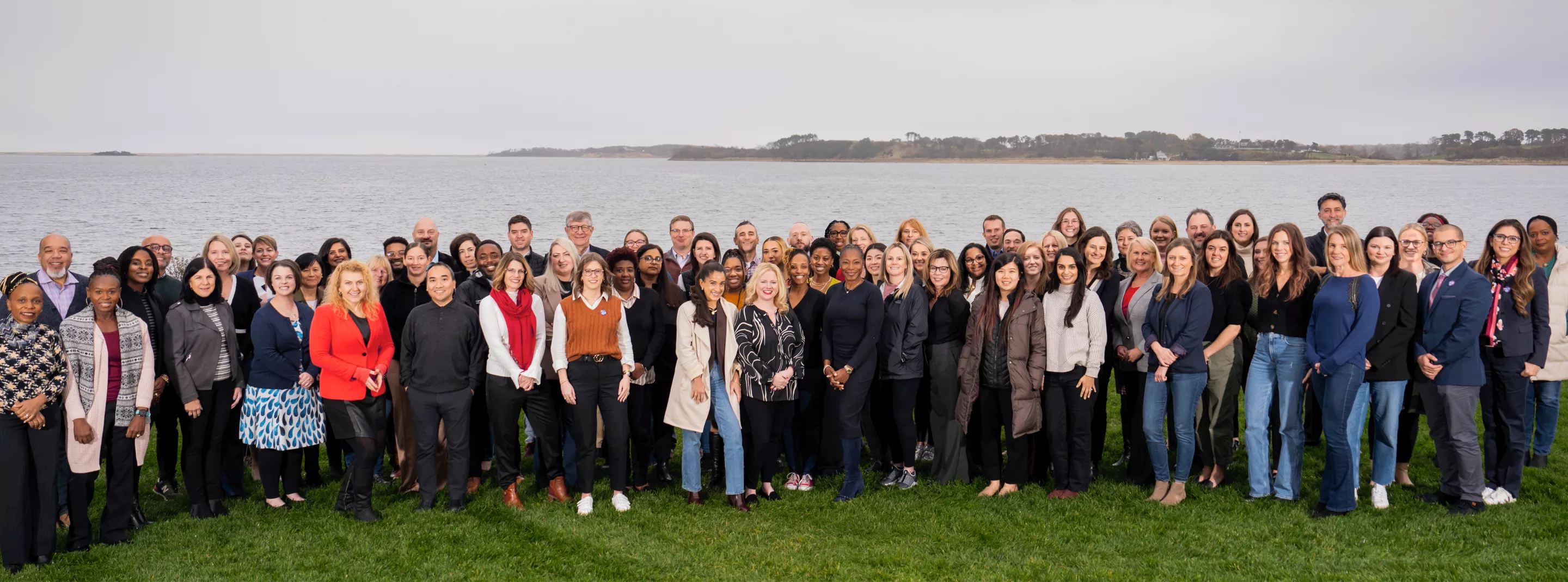 CareQuest Institute staff pose in front of ocean at staff retreat
